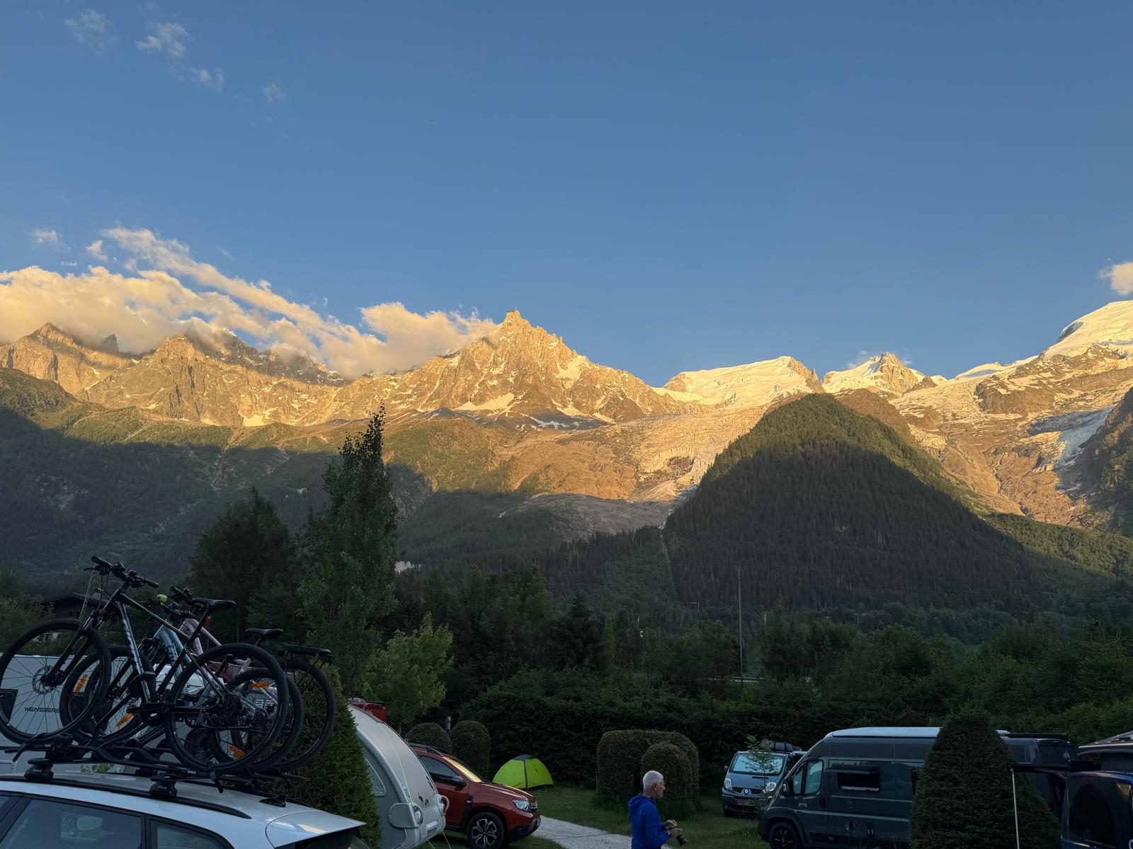 Sunset alpenglow on the Mont Blanc massif and the Aiguille du Midi spire, seen from the Chamonix campsite.